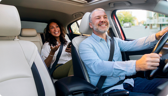 Smiling driver and passenger on an ASAP Prime Time Rideshare trip