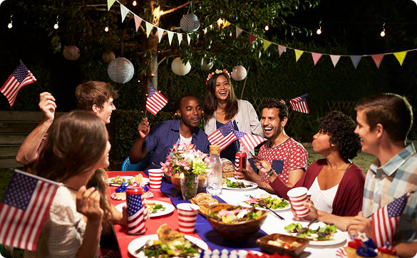 Friends and family enjoying a Fourth of July backyard dinner together