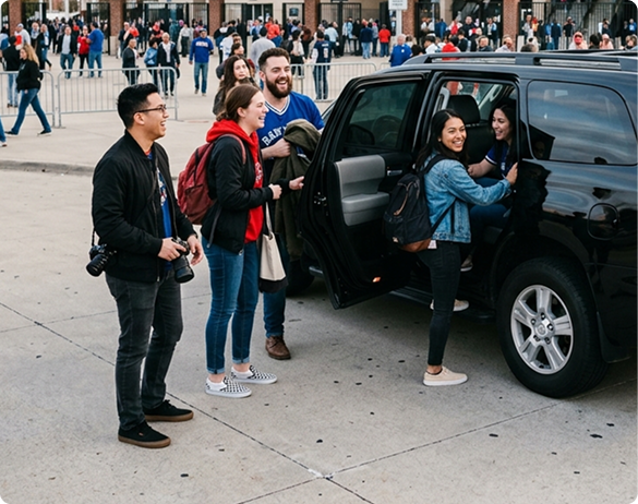 Fans being picked up by a Prime Time Rideshare SUV outside a stadium