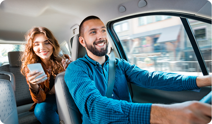 Happy passengers in a Prime Time Rideshare vehicle