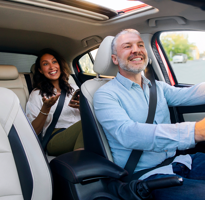 Happy passengers in a Prime Time Rideshare vehicle