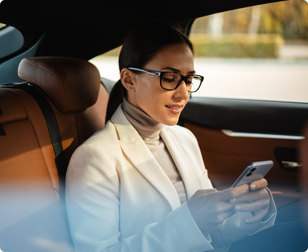 Passenger booking a ride from the back seat of a Prime Time Rideshare vehicle