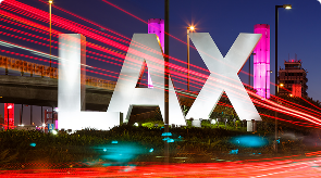 LAX iconic letter sign at night with light trails
