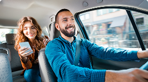 Passenger using a rideshare app while traveling with a driver